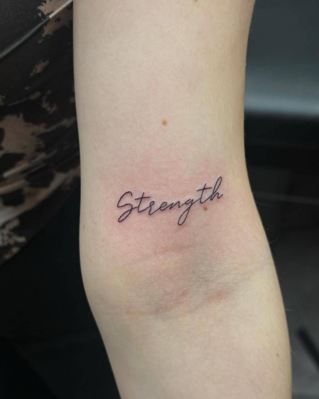 Elegant Strength Tattoo in Script Font