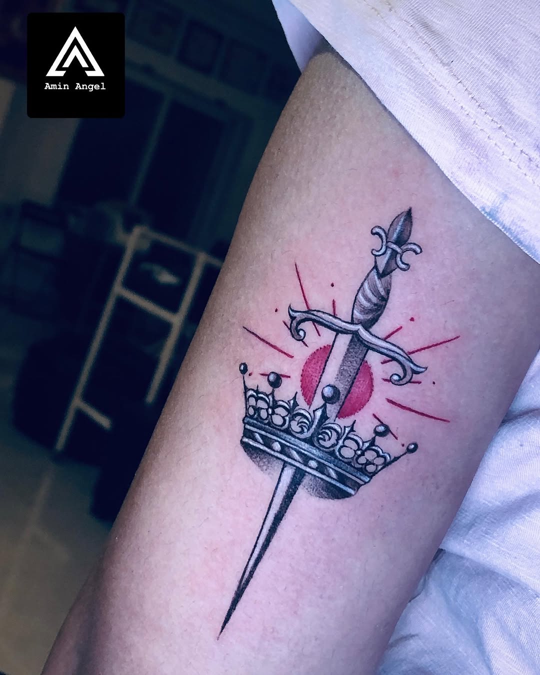Symbolic dagger and crown tattoo design