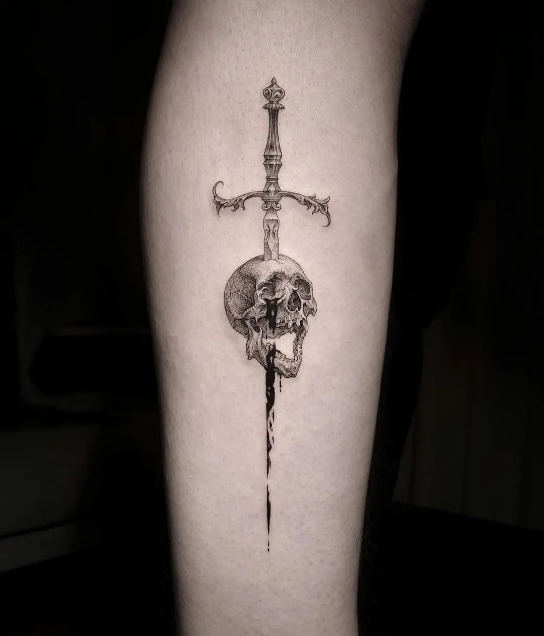 Dark elegance of sword and skull tattoo