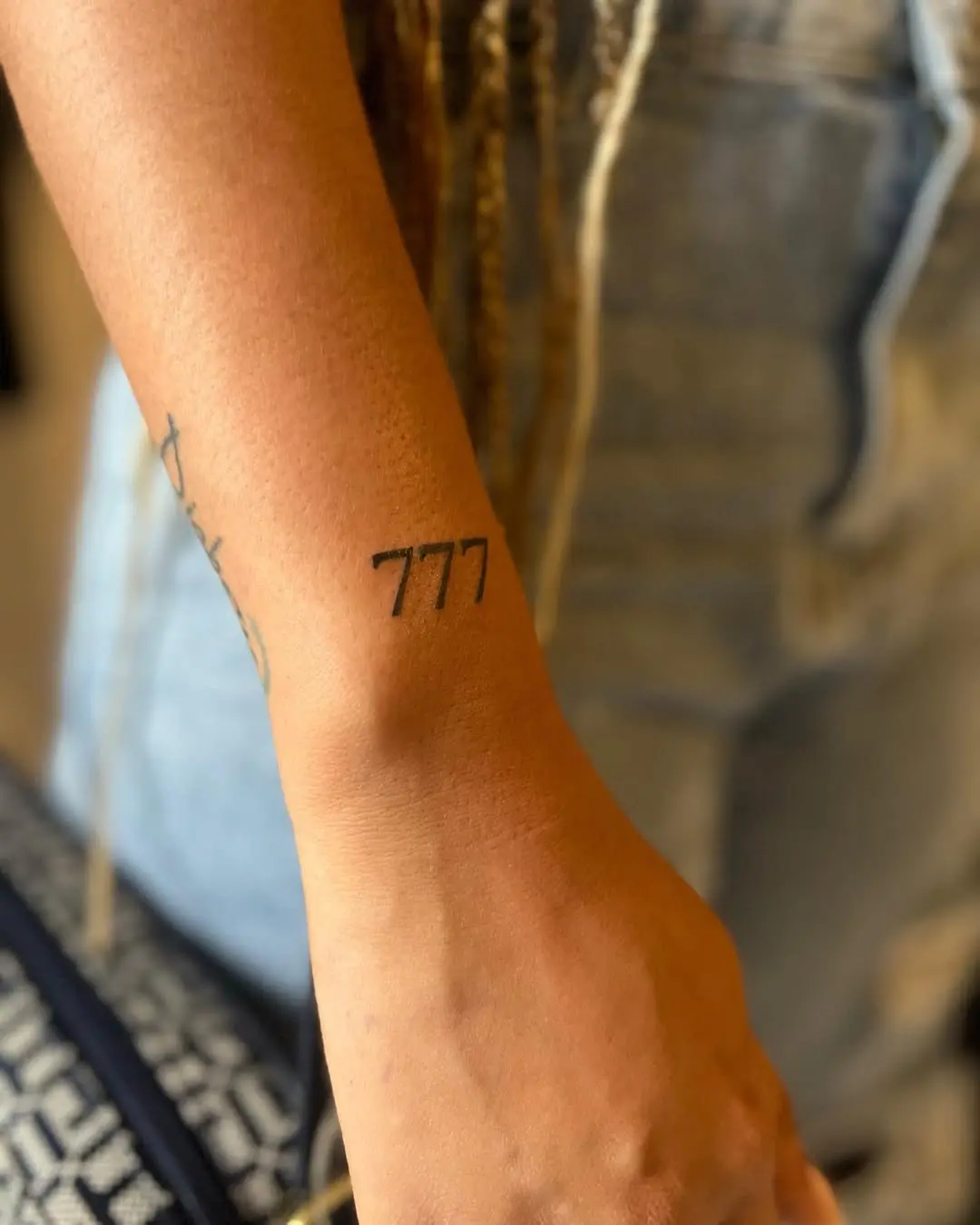 Minimalist 777 Tattoo Design on Forearm