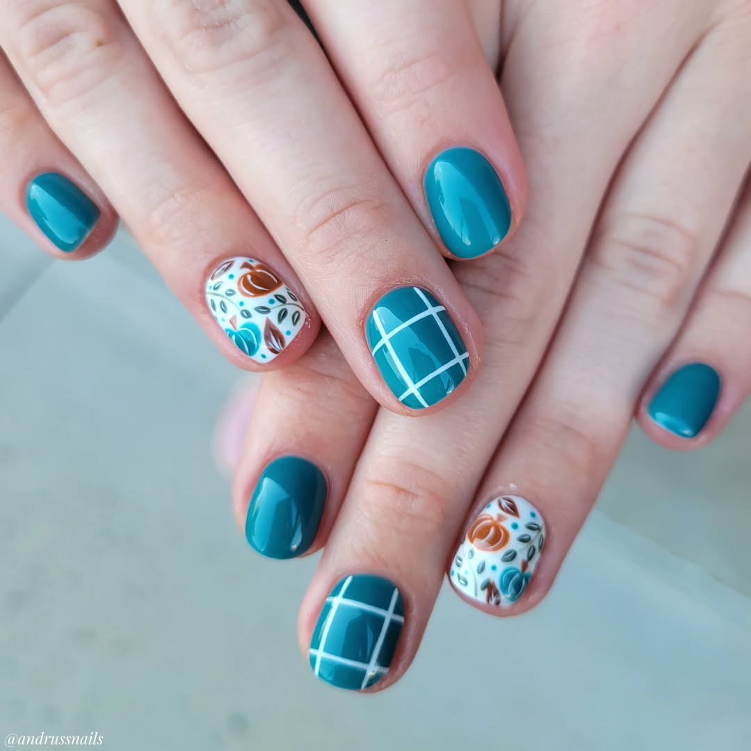 Stylish teal nails with intricate floral designs