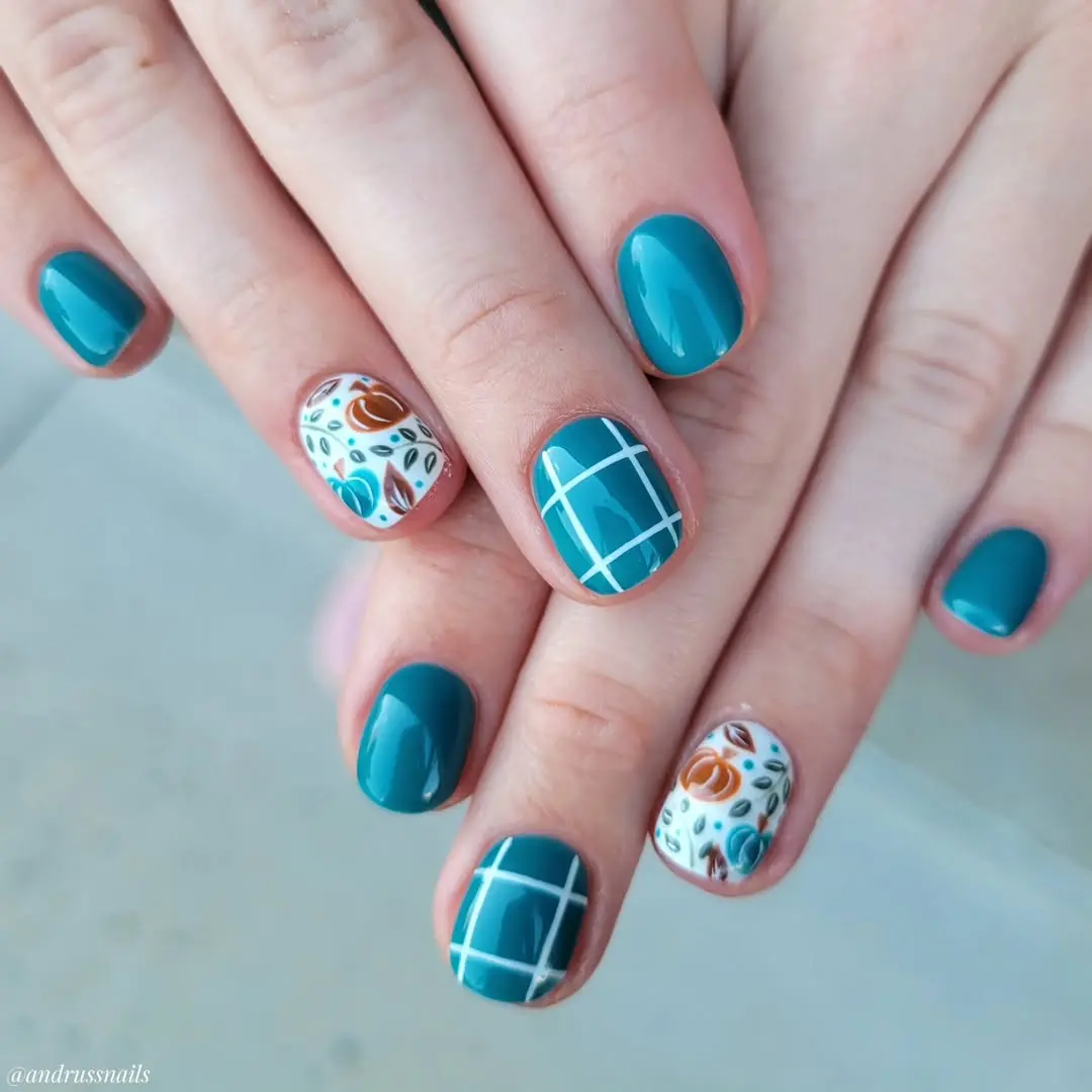 Stylish teal nails with intricate floral designs