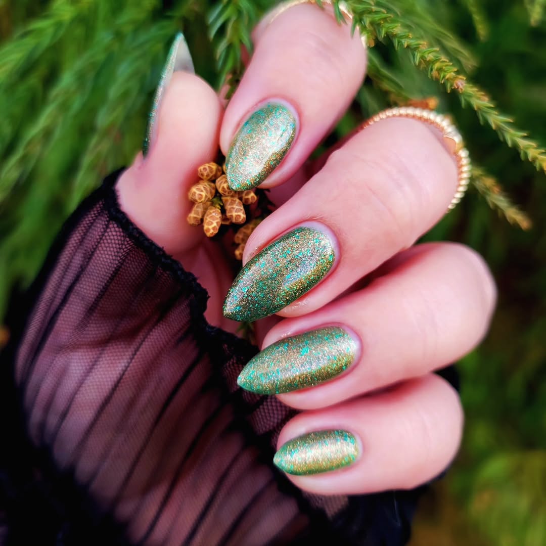 Vibrant teal nails with sparkling finish