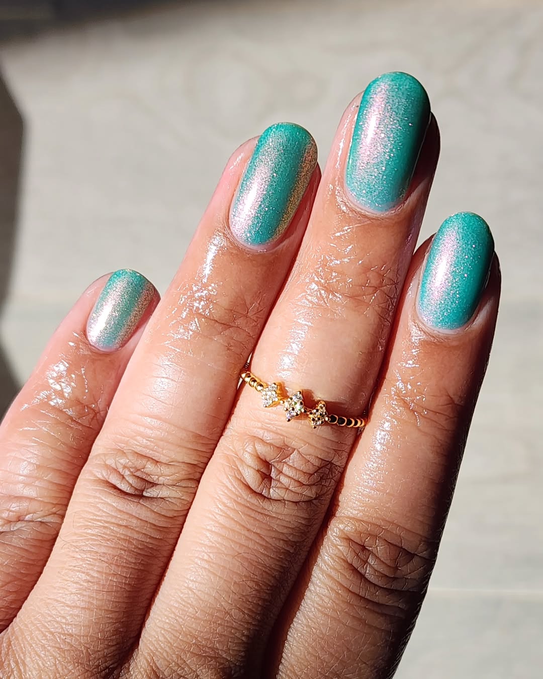 Glistening teal nails with beautiful shimmer effects