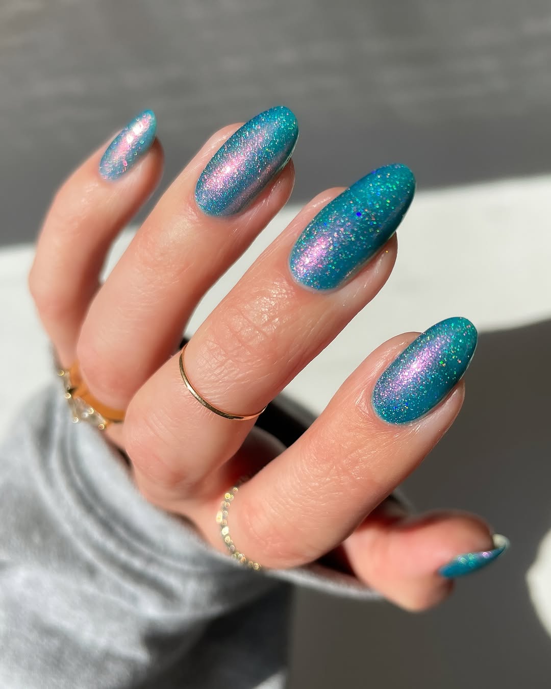 Stunning teal nails with a holographic sparkle