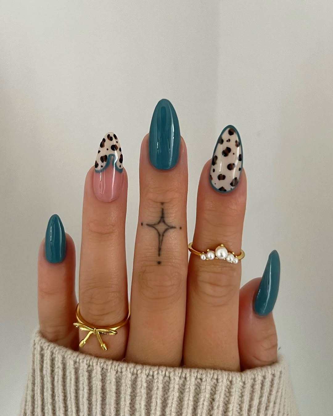 Chic teal nails with playful leopard accents