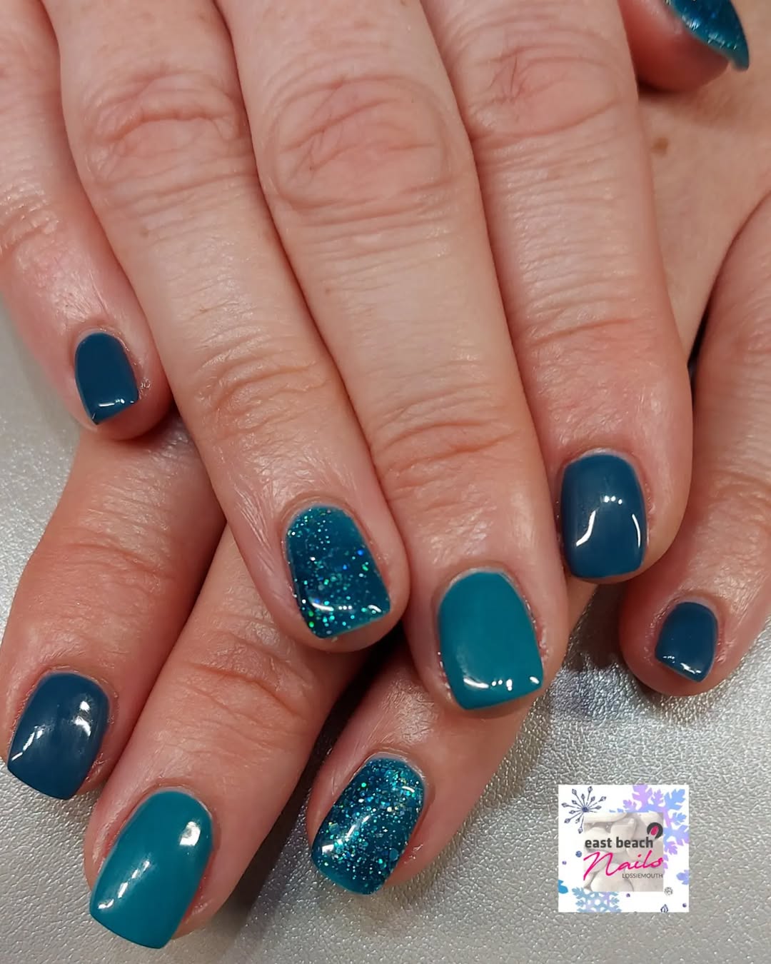 Chic teal nails with stunning glitter accents