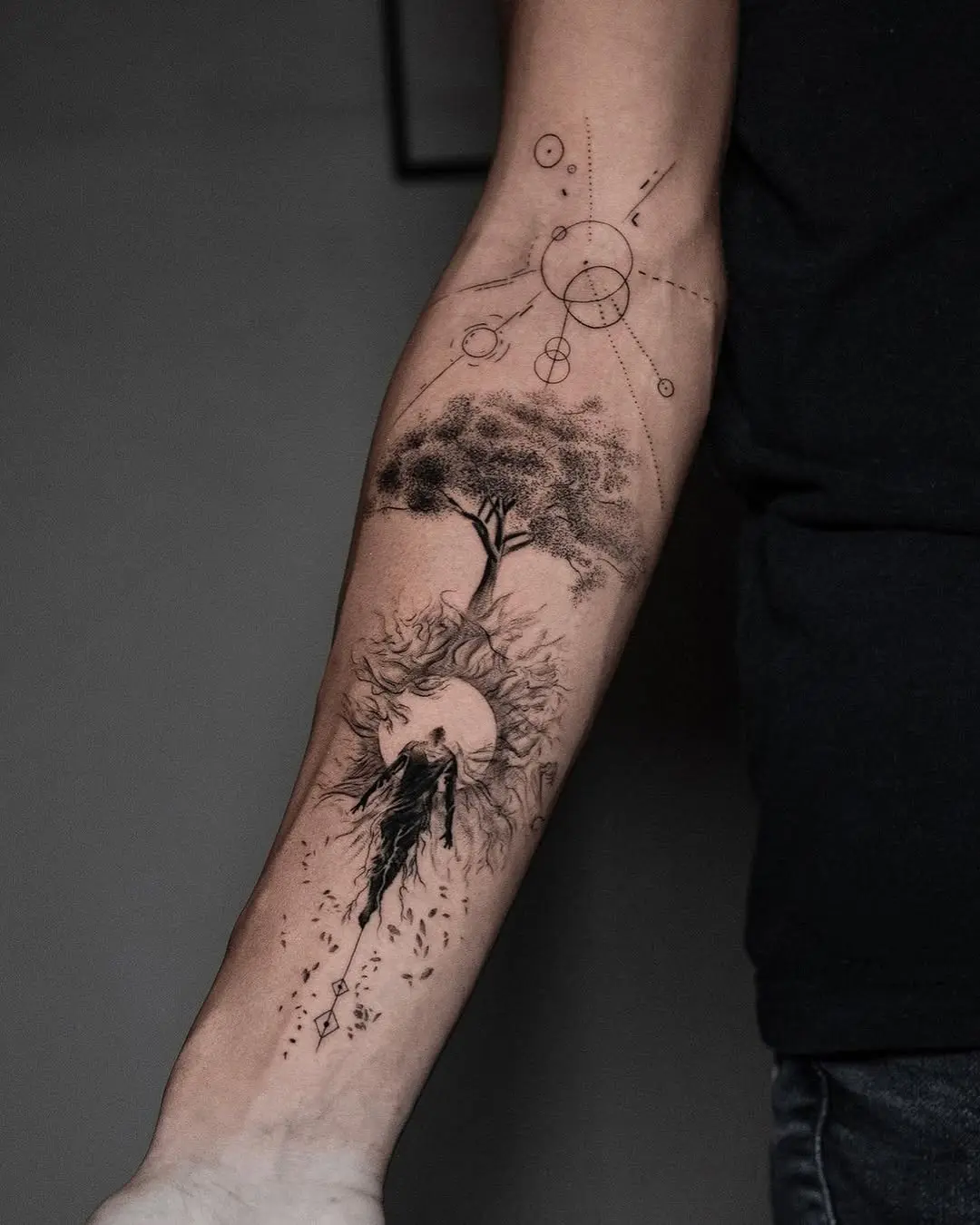Artistic tree tattoo with cosmic elements