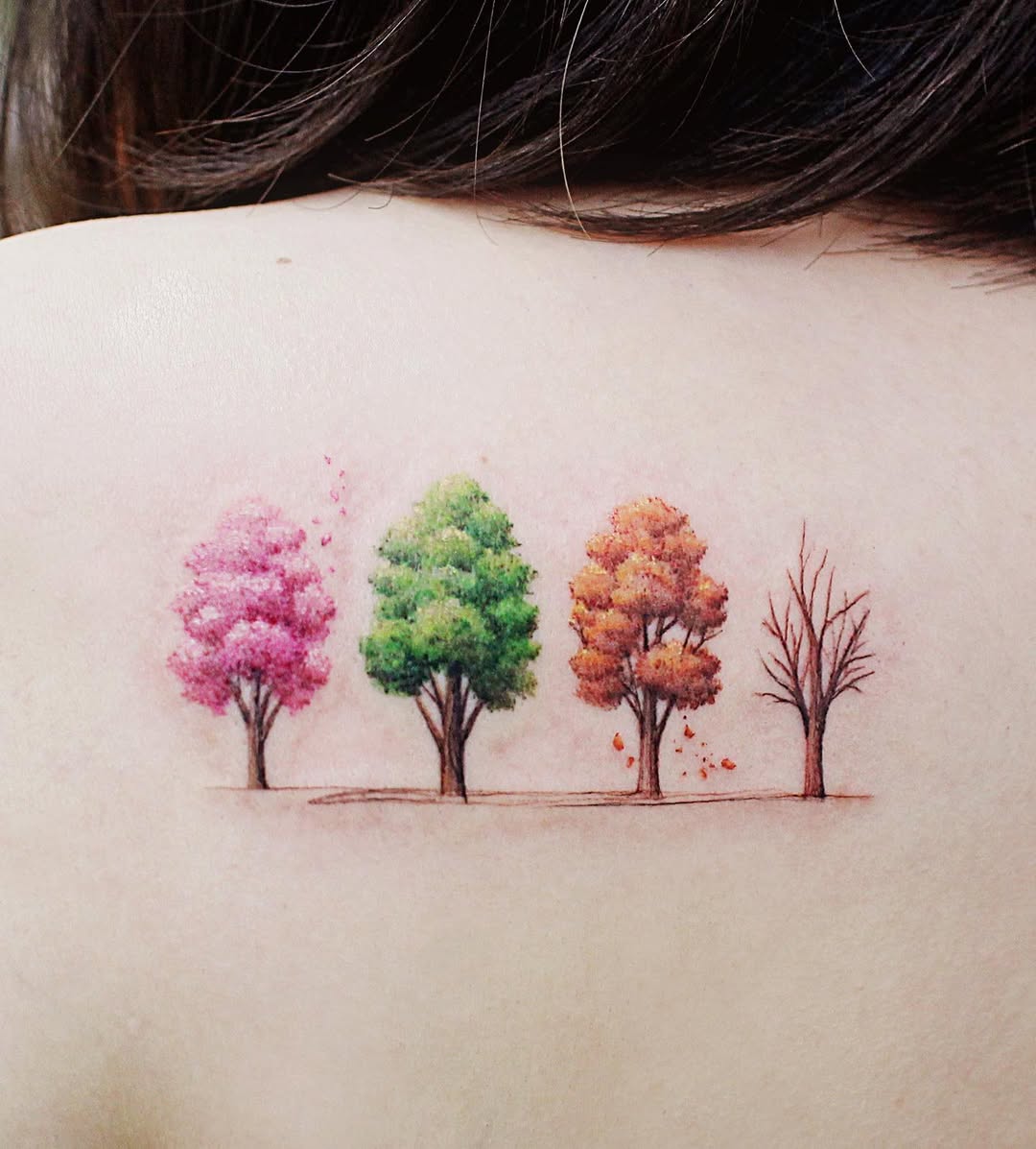 Vibrant seasonal tree tattoo on shoulder