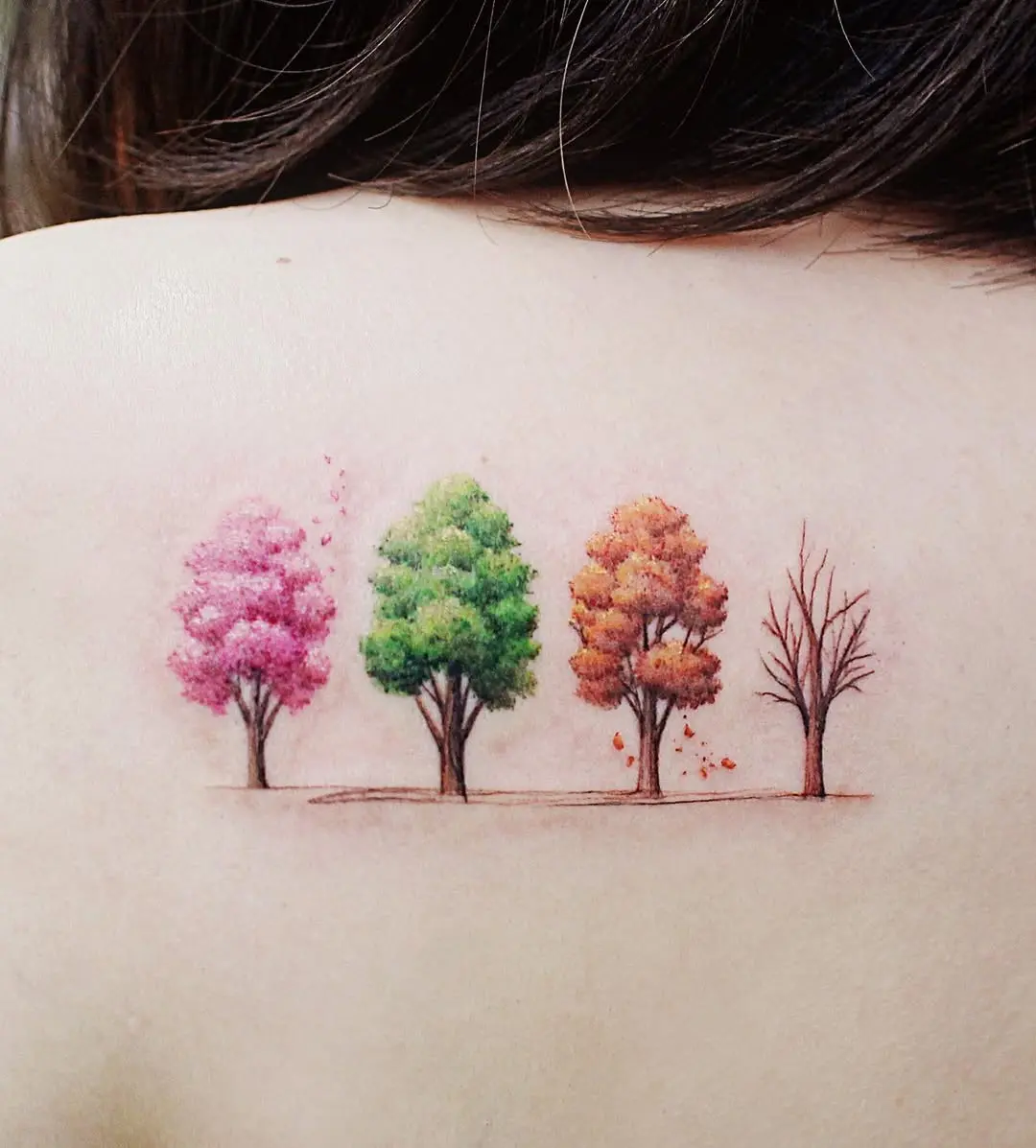 Vibrant seasonal tree tattoo on shoulder