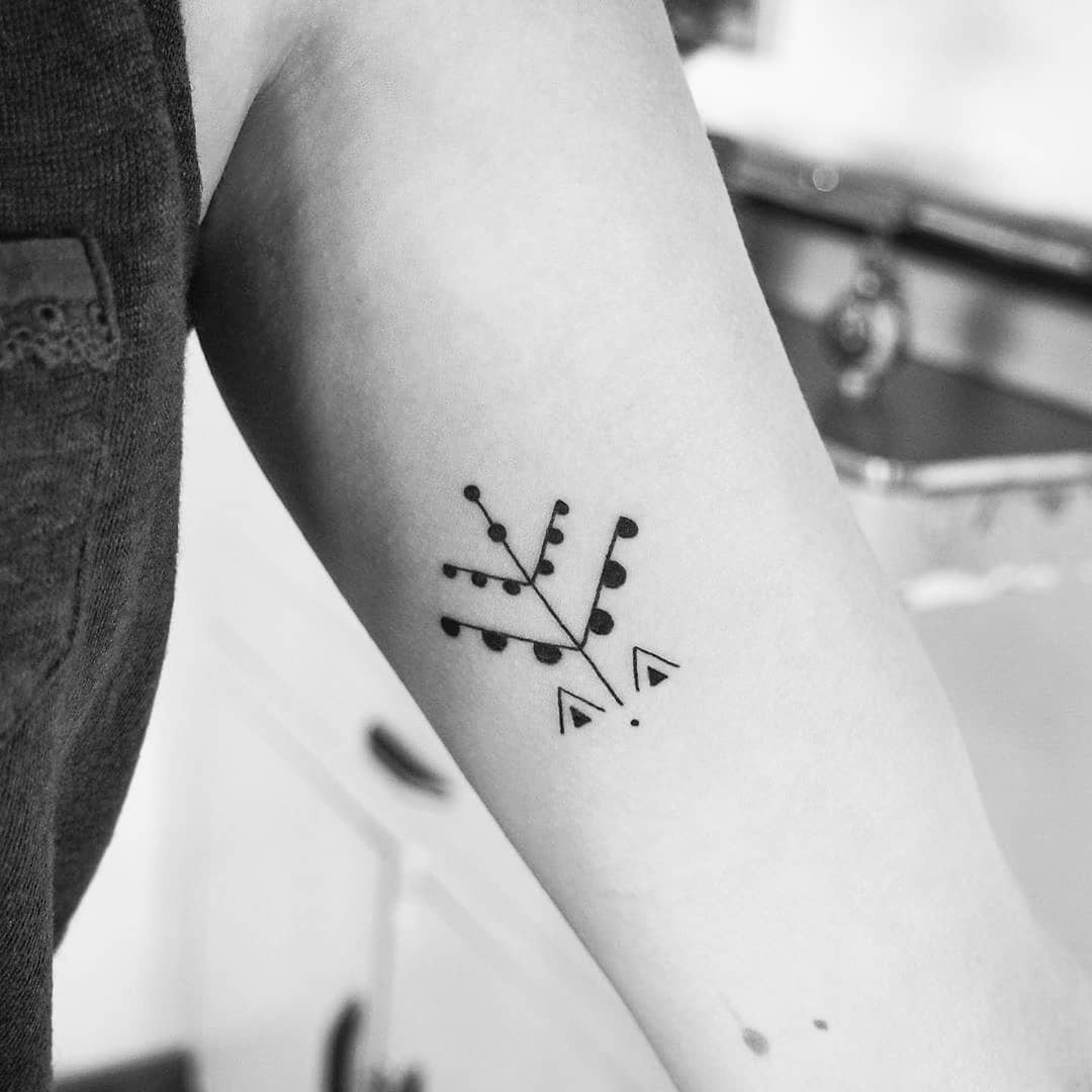 Stylish geometric tree tattoo design in black ink