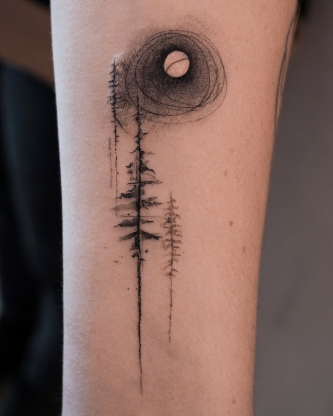 Minimalist tree tattoo with a moon motif