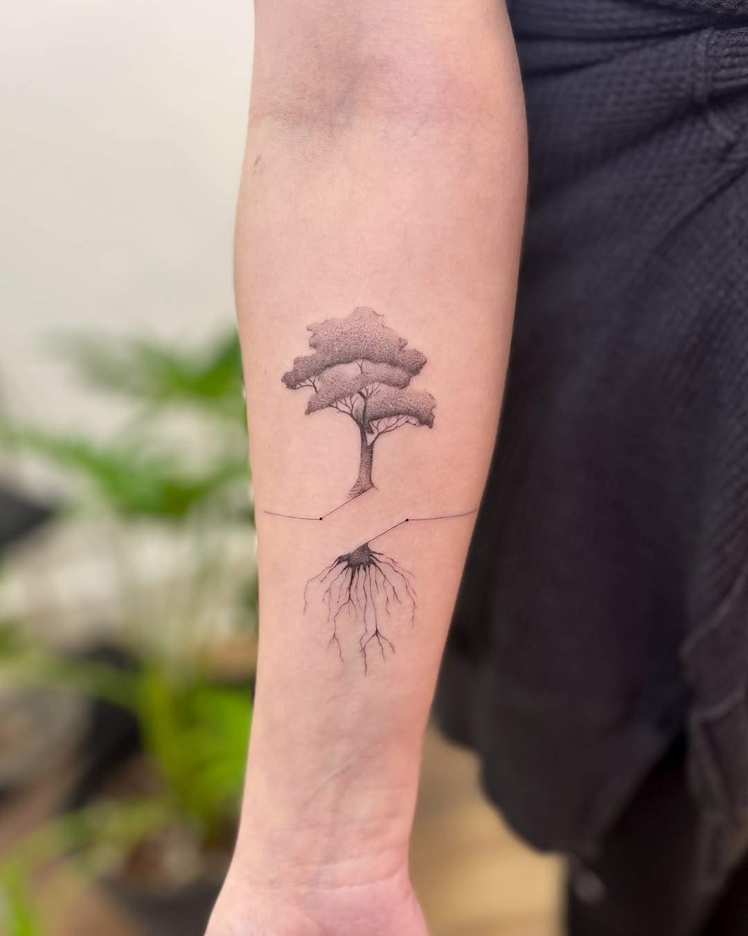 Symbolic tree tattoo with roots design.