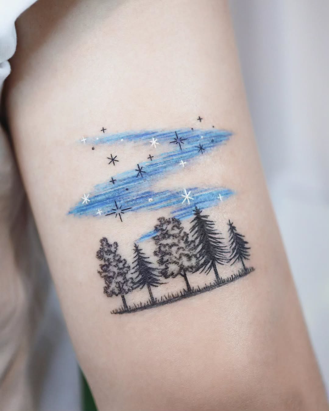 Enchanting tree tattoo under a starry sky