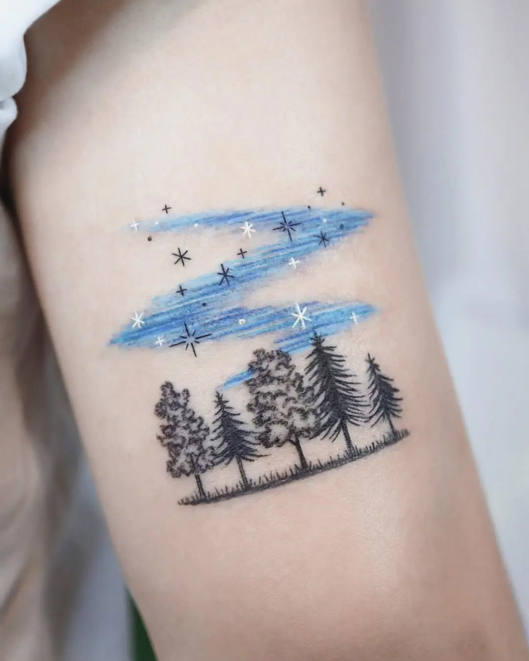 Enchanting tree tattoo under a starry sky