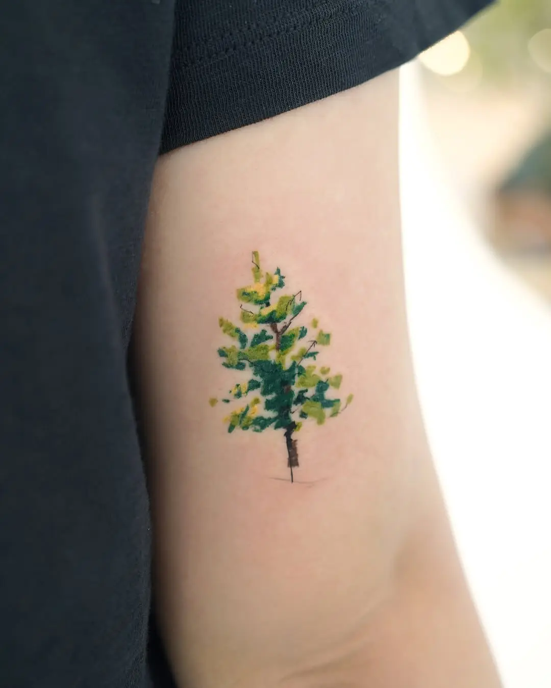Colorful tree tattoo with artistic flair