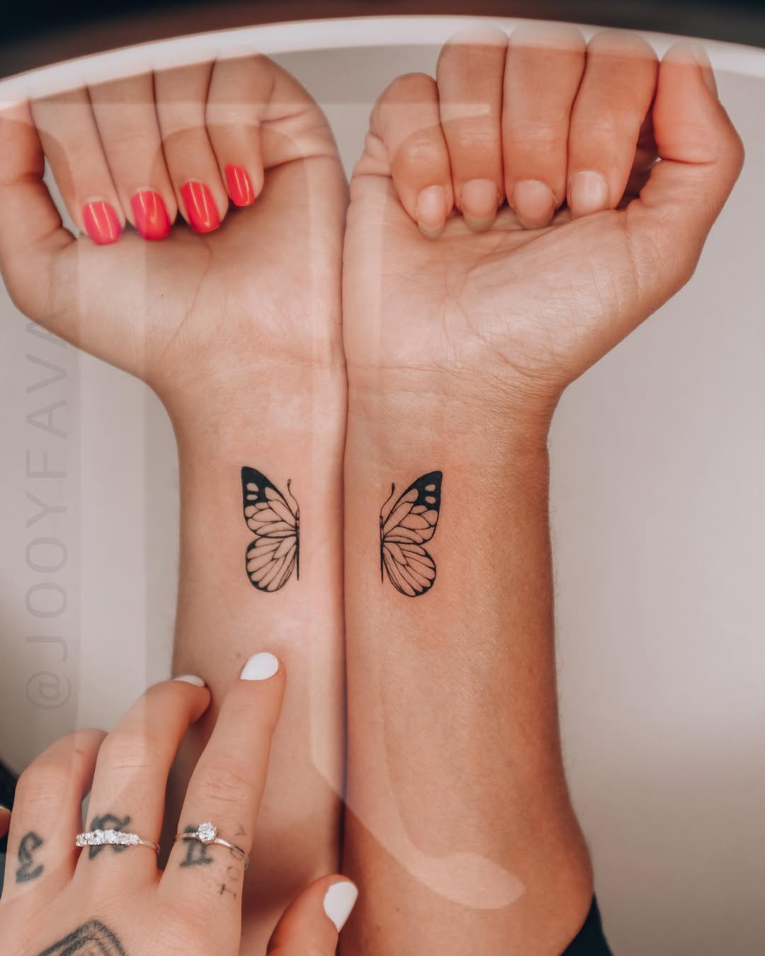 Symbolic twin butterfly tattoos on wrists