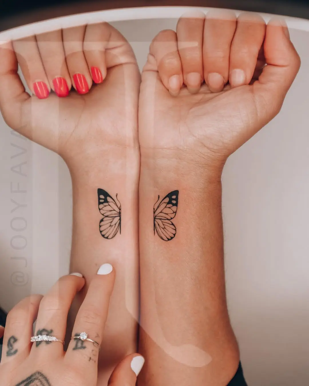 Symbolic twin butterfly tattoos on wrists