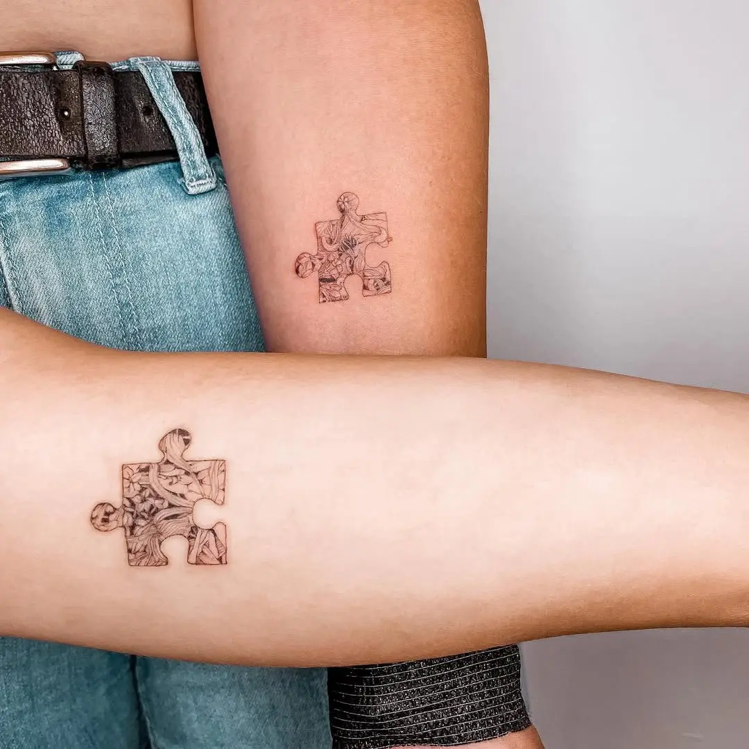 Interlocking puzzle piece twin tattoos highlight connection