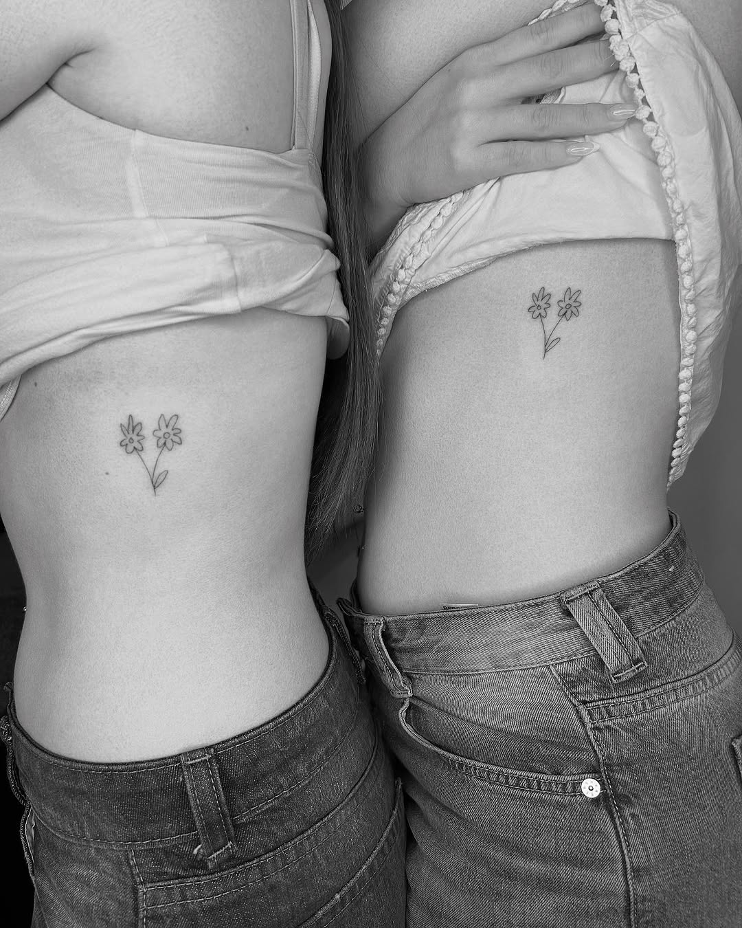 Delicate floral twin tattoos on skin
