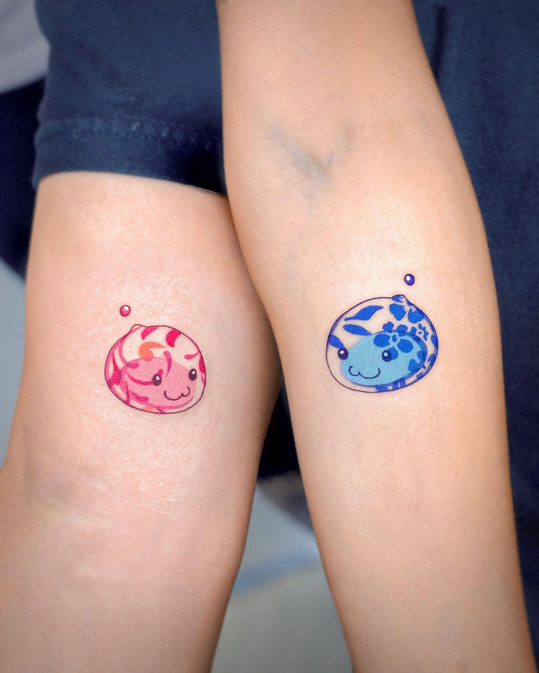 Adorable twin tattoos of playful aquatic creatures