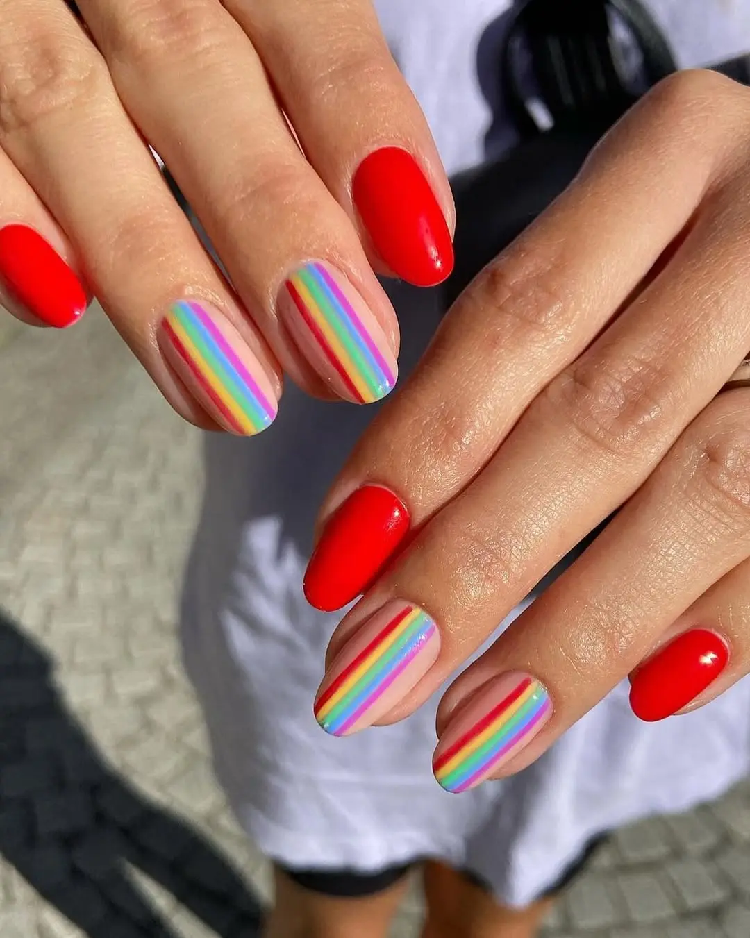 Bold rainbow accents on classic red nails
