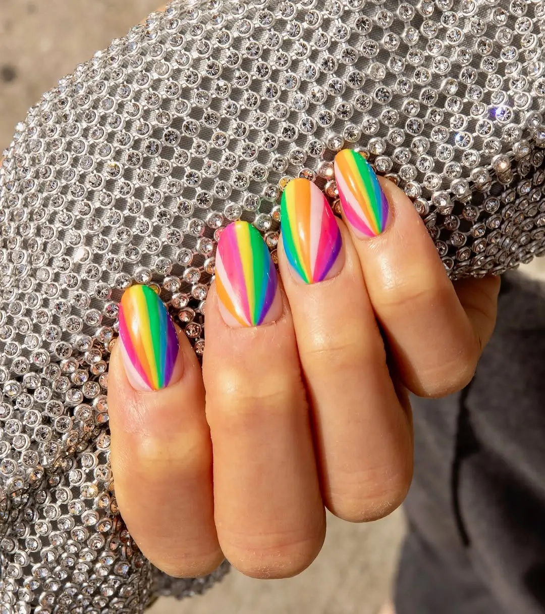 Vibrant rainbow nails with sparkling elegance