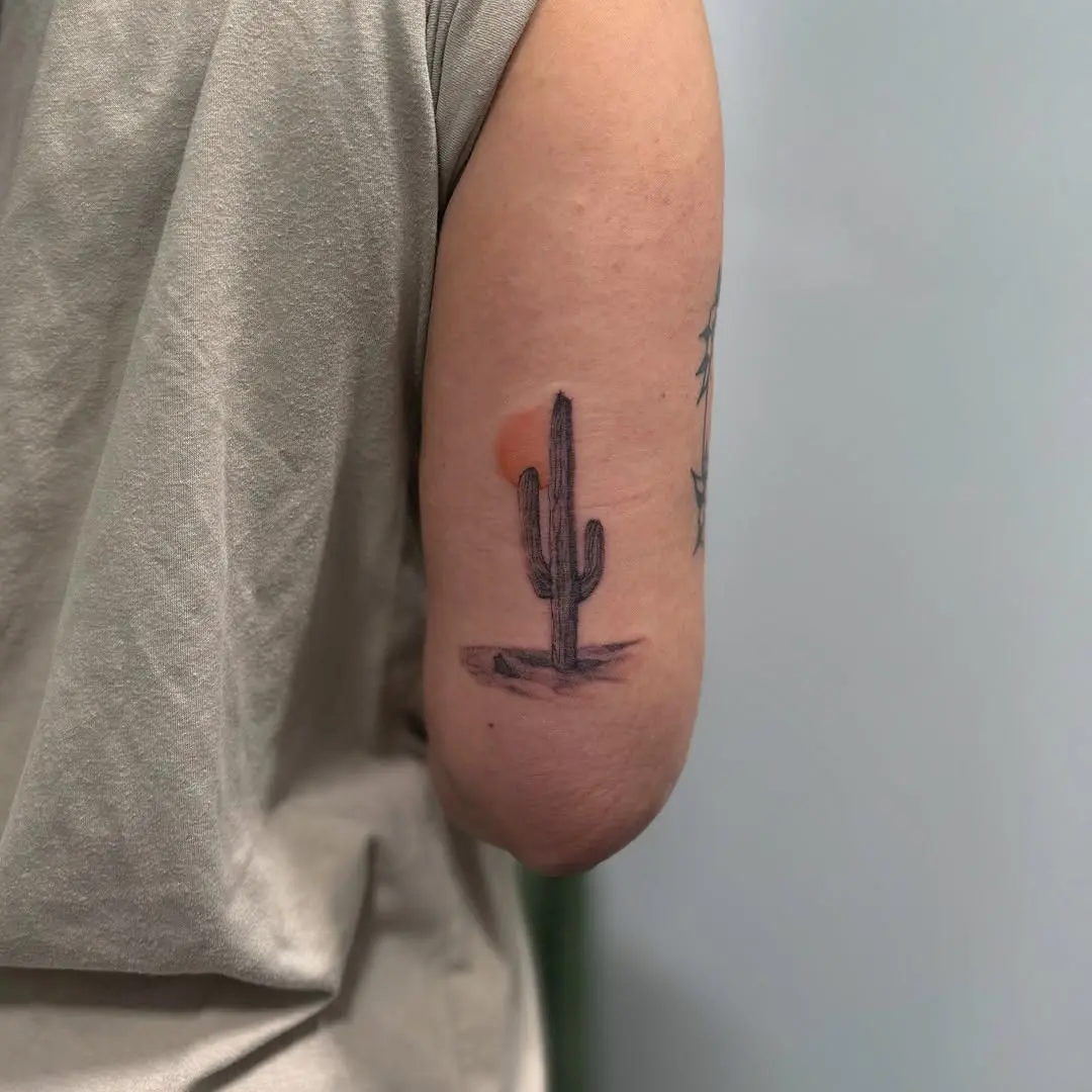 Minimalist cactus tattoo with sunset vibes