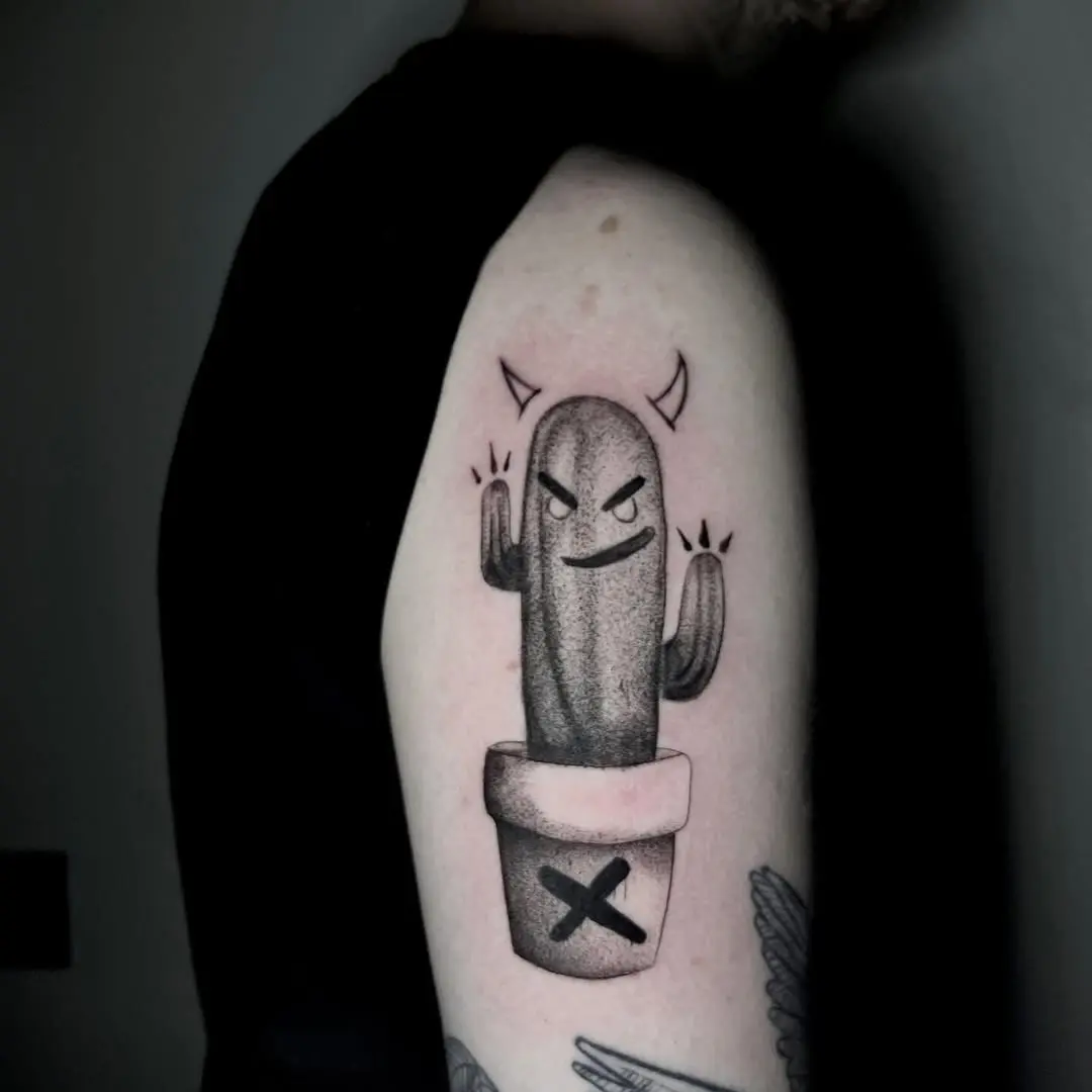 Whimsical cactus tattoo with a quirky expression