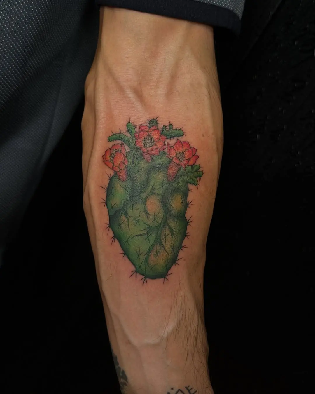 Vibrant cactus heart tattoo with flowers