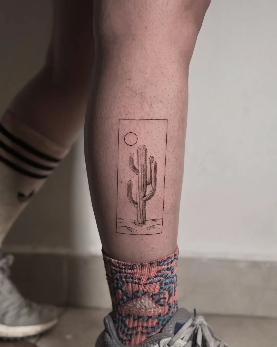 Stylish minimalist cactus tattoo on the leg