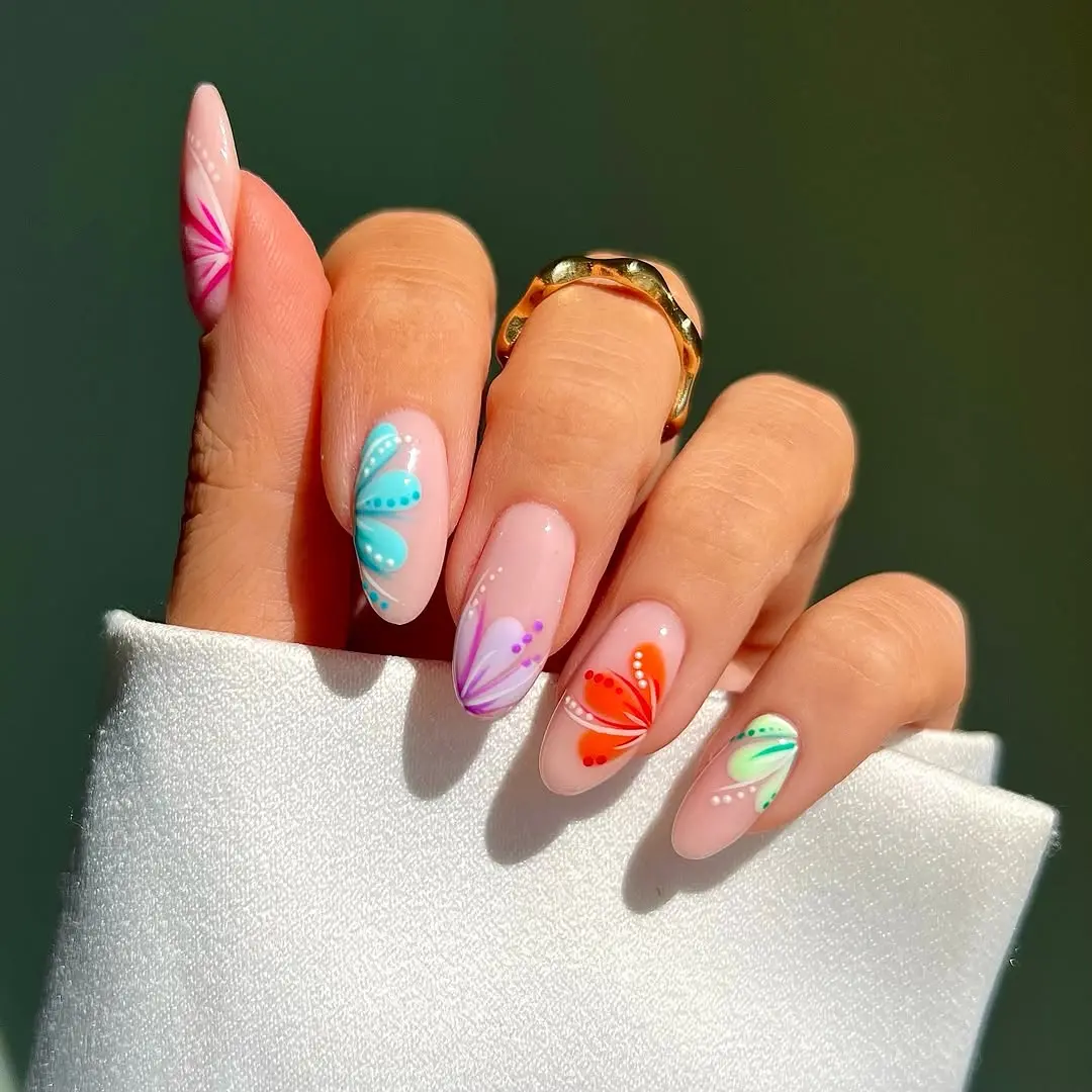 Vibrant butterfly designs for summer nails.