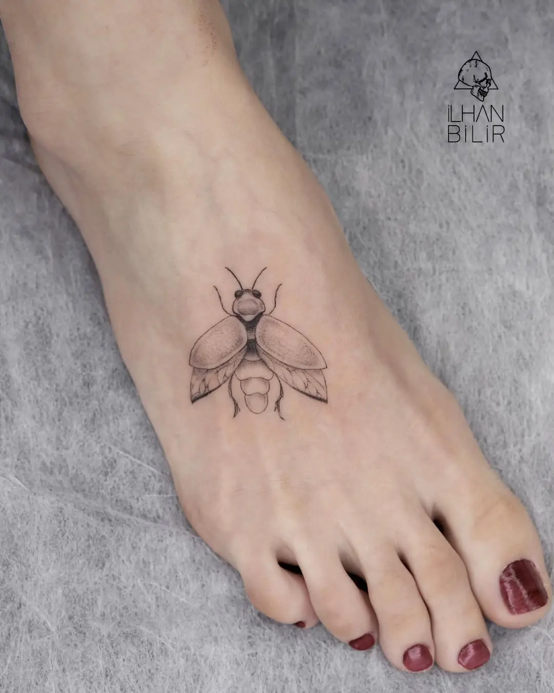 Elegant firefly tattoo on the foot