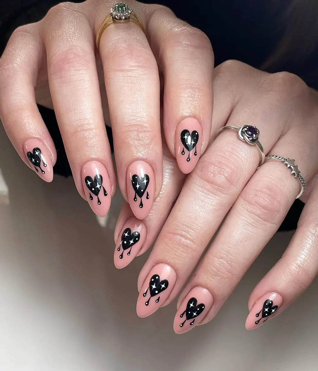 Stylish heart nails with dramatic black drops