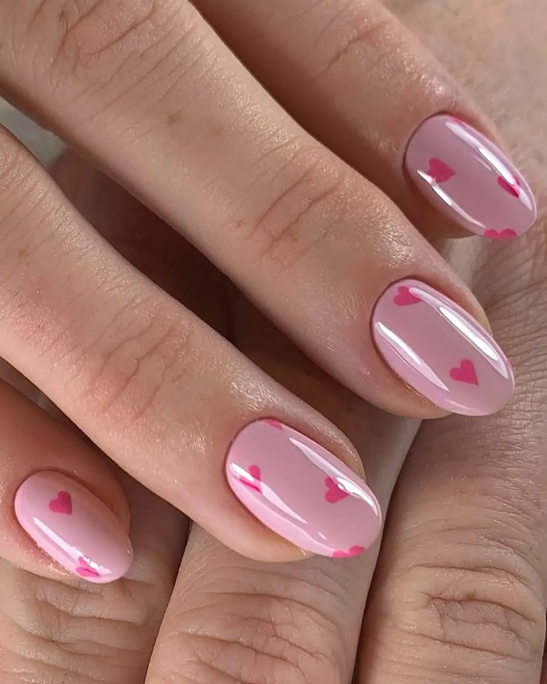 Charming pink heart nail design for every occasion.