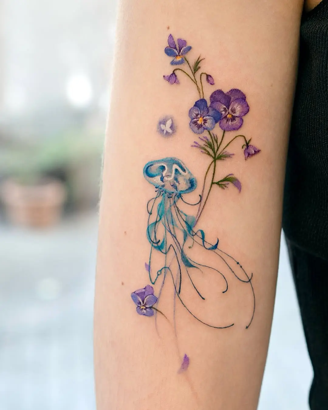 Intricate jellyfish and floral tattoo design