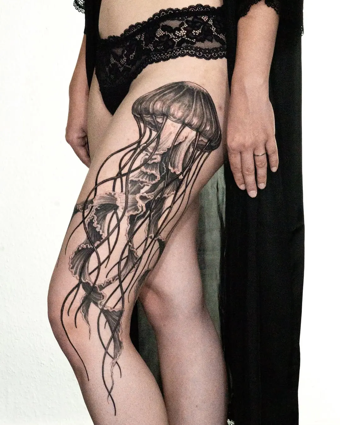 Elegant jellyfish tattoo on feminine thigh