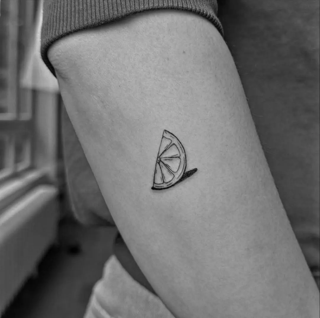 Charming Black and White Lemon Slice Tattoo
