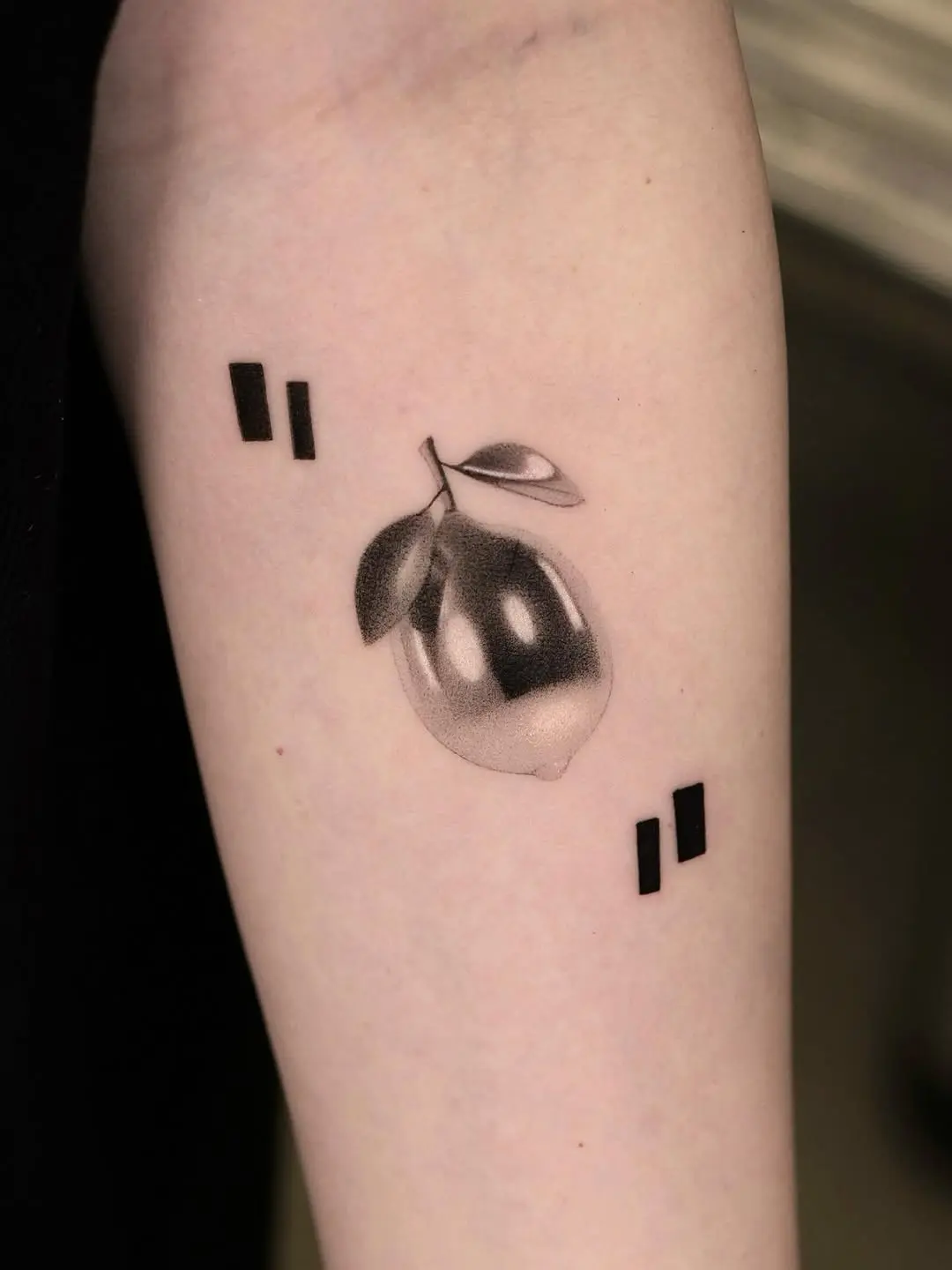 Elegant black and gray lemon tattoo design