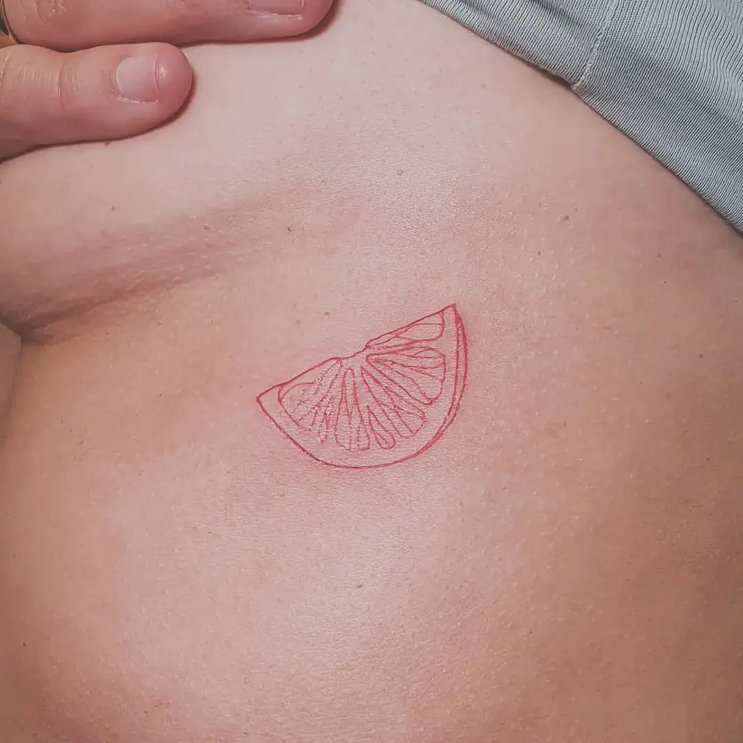 Playful Red Lemon Slice Tattoo Design