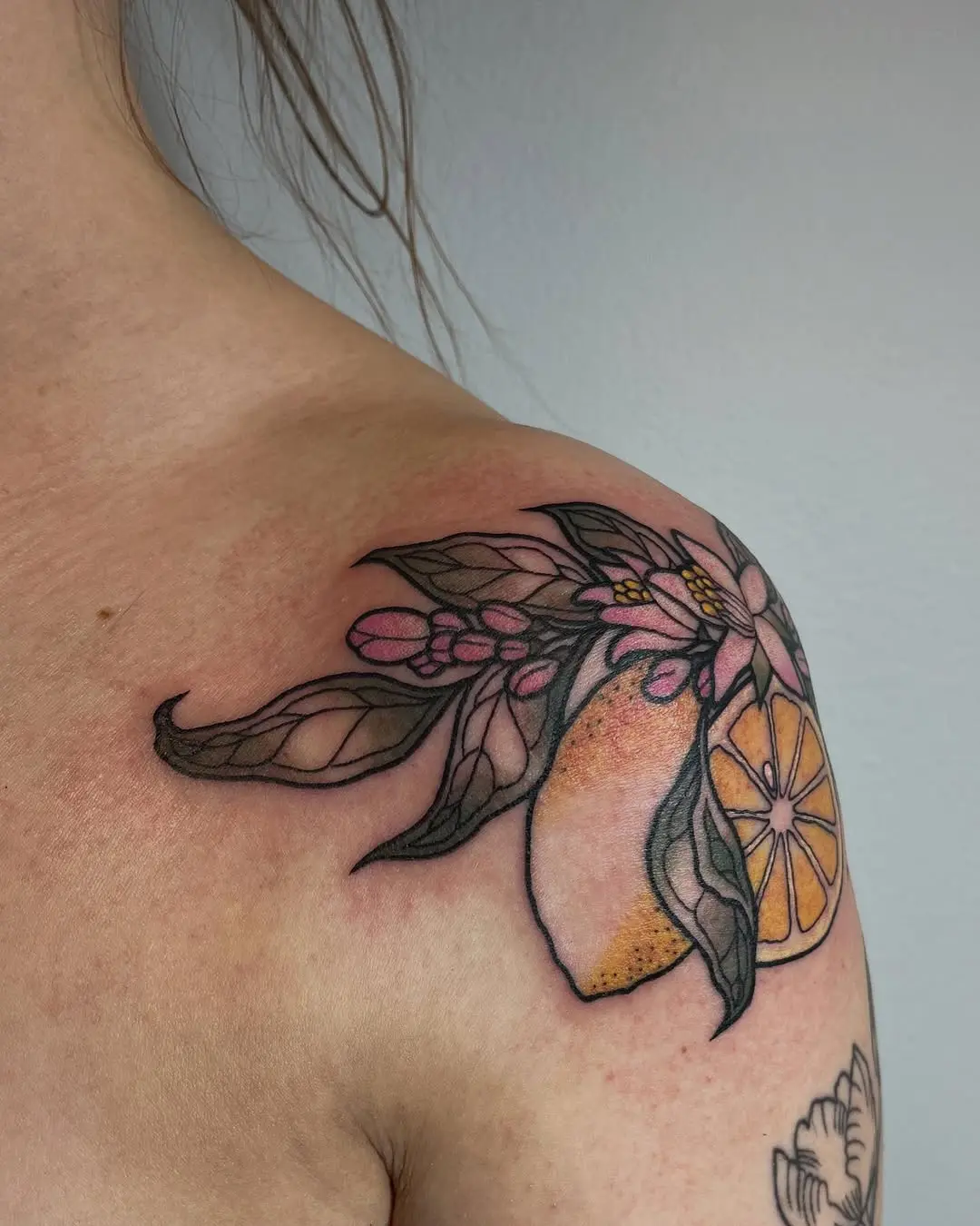 Vibrant Lemon Tattoo with Floral Elements