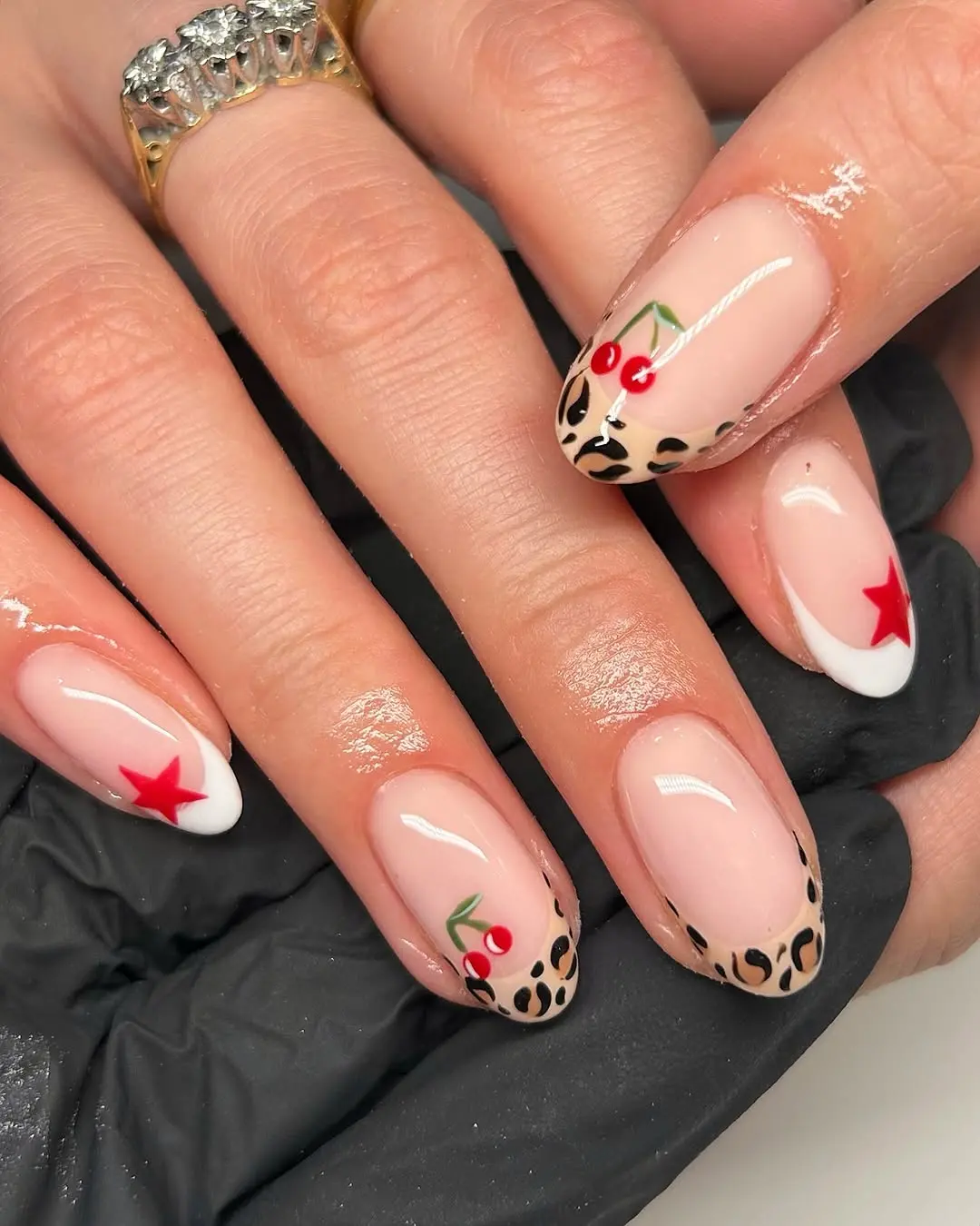Playful leopard nails with cherry and star accents