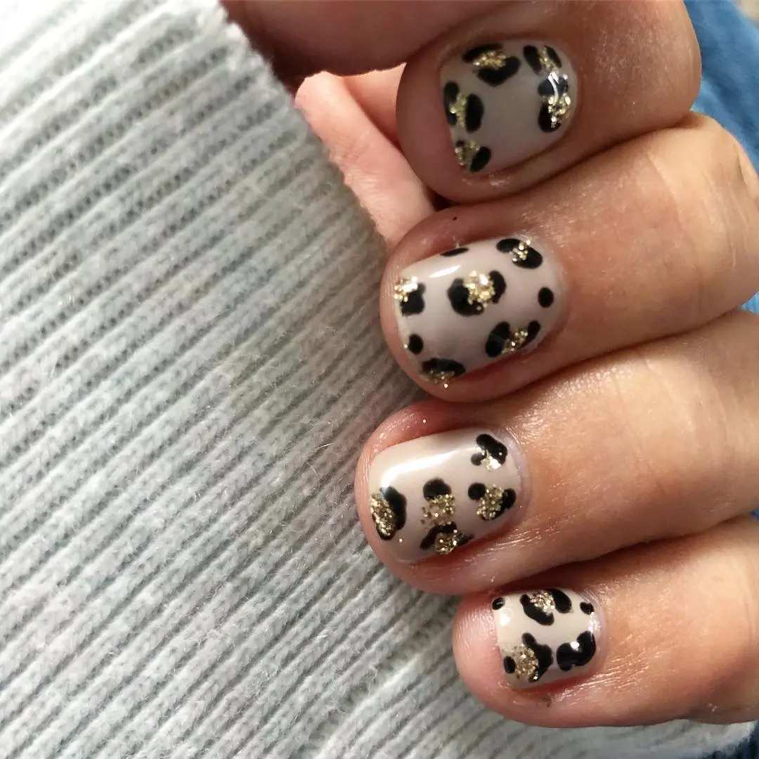 Chic leopard nail design with glitter accents