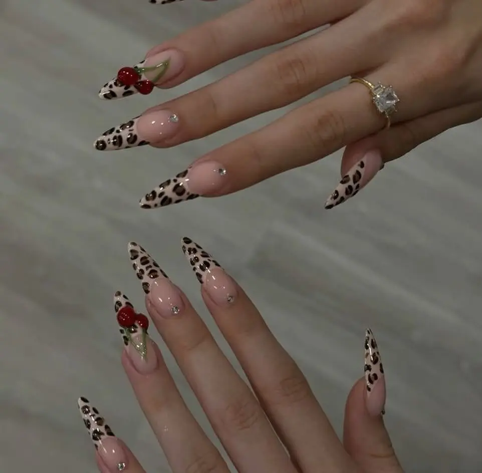Stylish leopard print nails with cherry accents