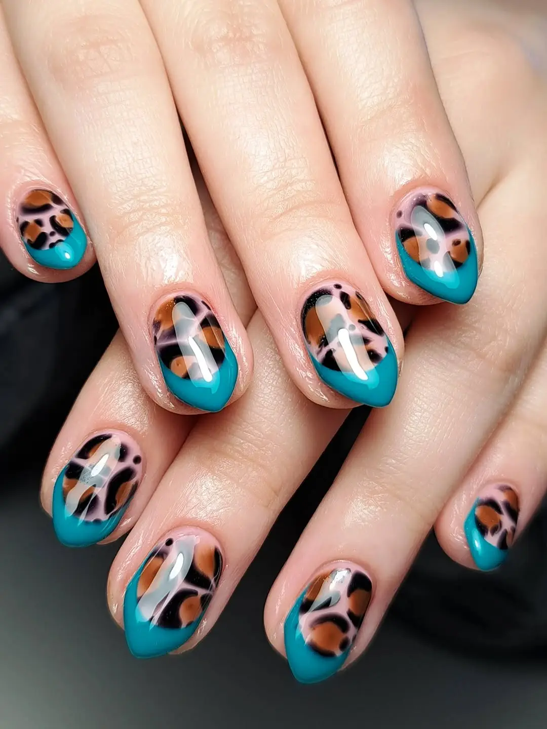 Stylish teal and leopard print nail design