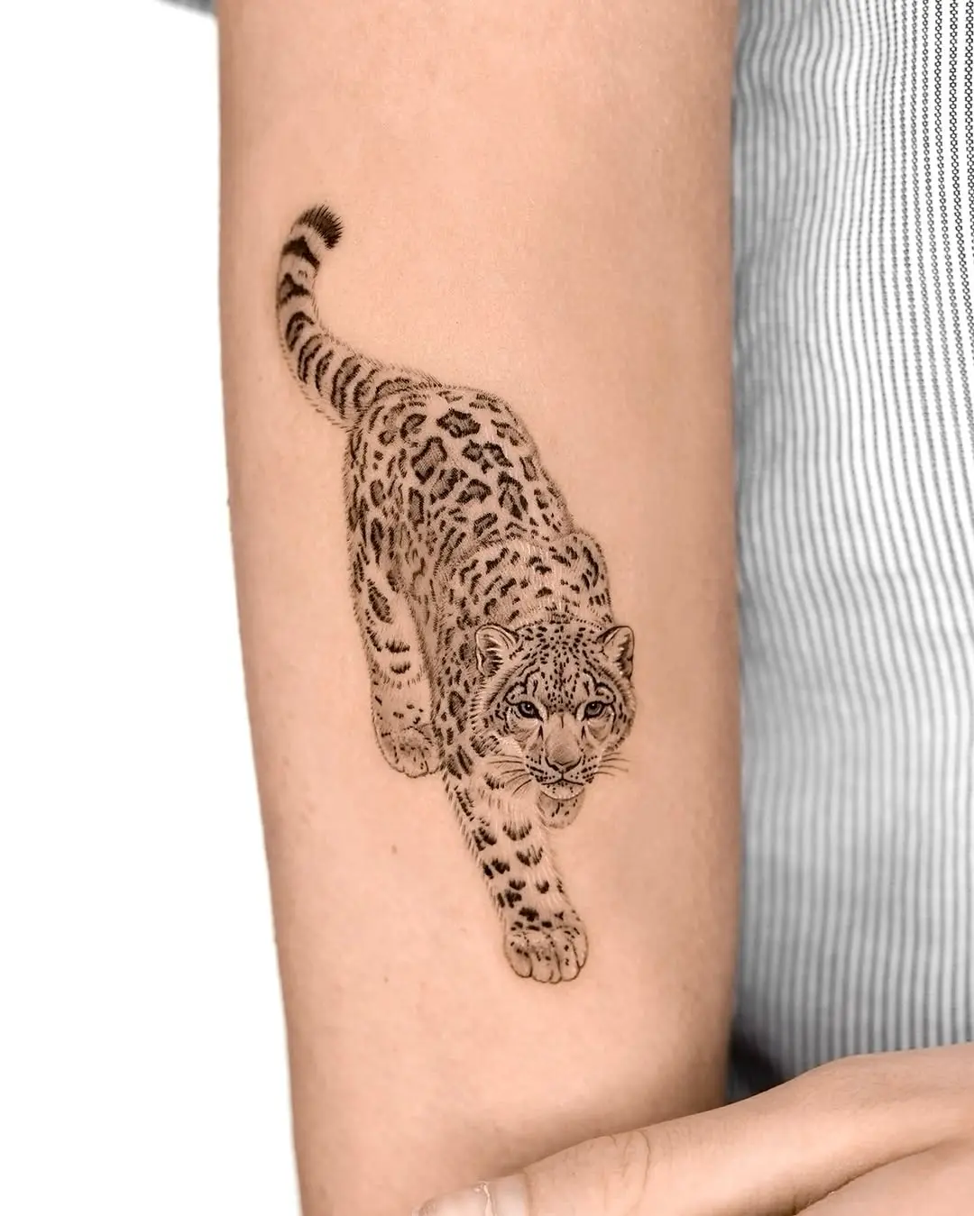 Dynamic leopard tattoo showcasing fierce elegance