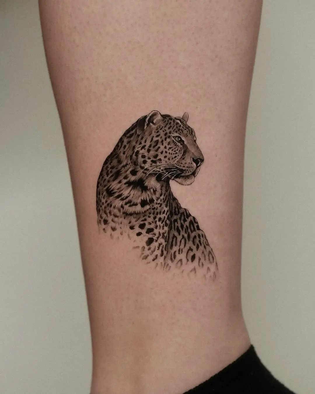 Elegant leopard tattoo showcasing fierce beauty
