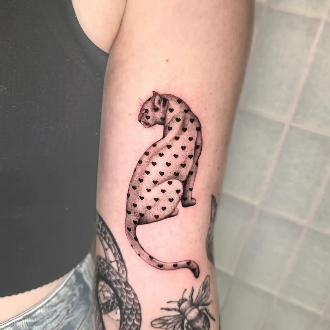 Stylish leopard tattoo with heart motifs