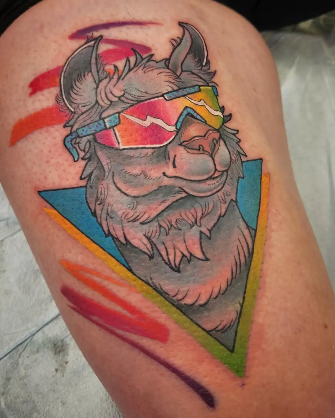 Colorful llama tattoo with vibrant geometric elements