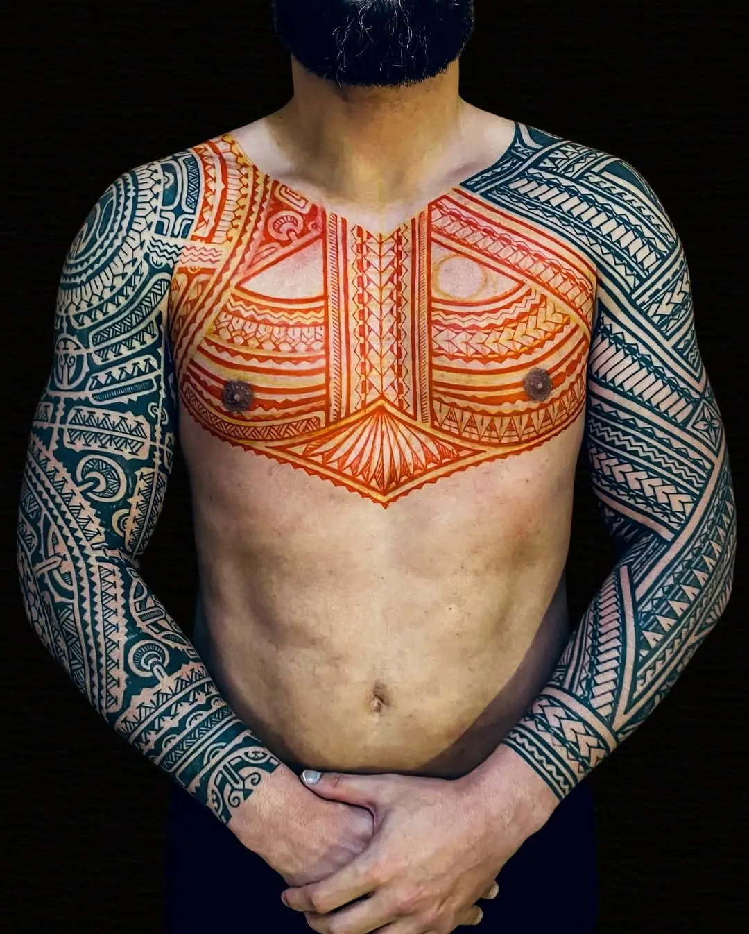 Intricate Marquesan tattoo artwork on the arms